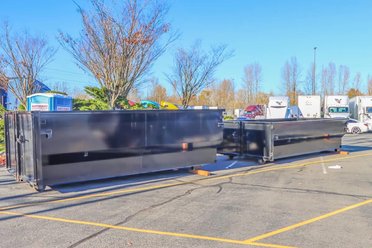 Professional dumpster rental service with roll-off container on residential driveway in Red Bluff